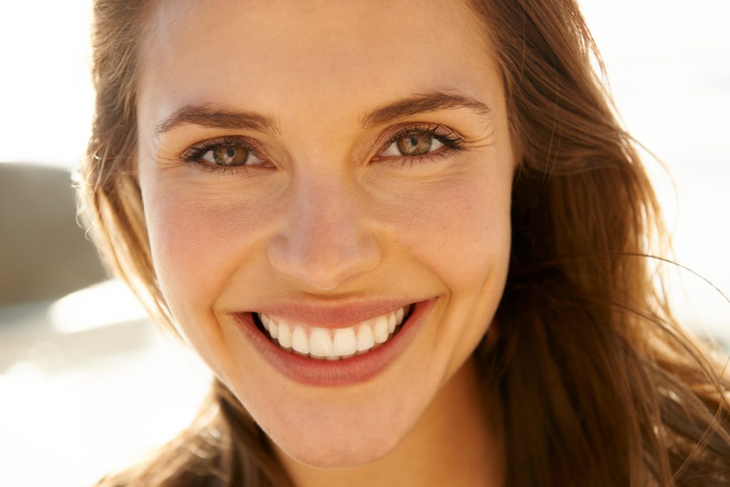 closeup of a woman with a perfect smile, dental veneers